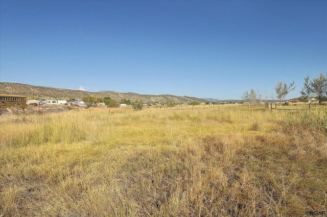 view of landscape with a rural view and a mountain view