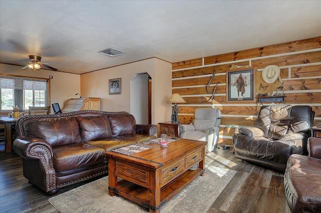 living room featuring ceiling fan and dark hardwood / wood-style floors