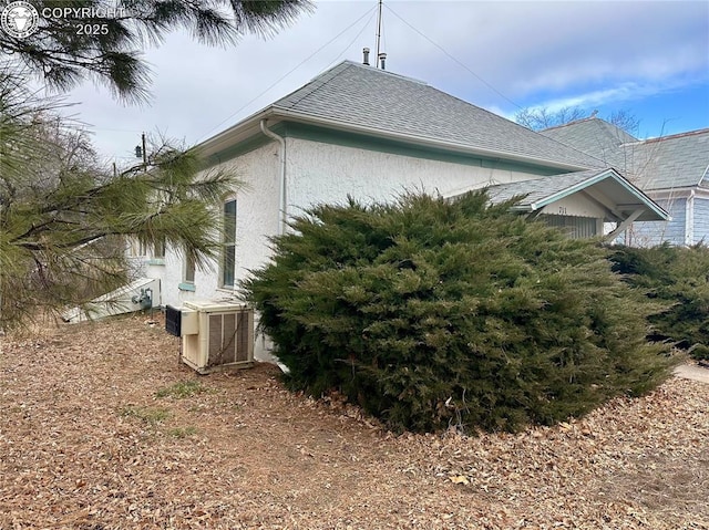 view of side of property with central AC