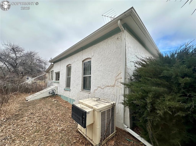 view of side of home featuring ac unit