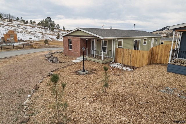 view of front of property with a porch and a mountain view