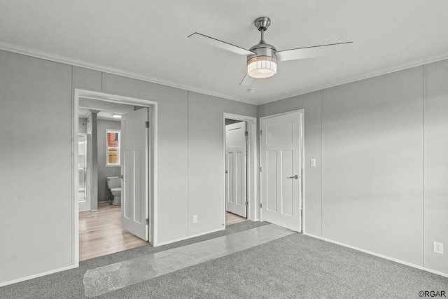 unfurnished bedroom featuring crown molding, light colored carpet, ceiling fan, and ensuite bath
