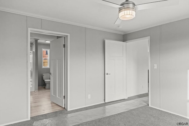 unfurnished bedroom featuring ornamental molding, light carpet, and ceiling fan