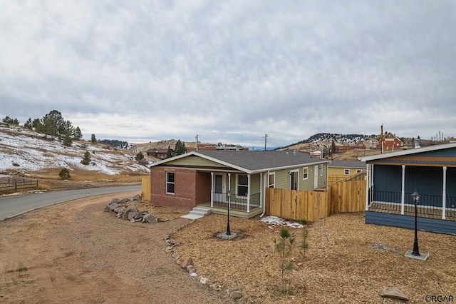 view of front of property featuring a mountain view and a porch