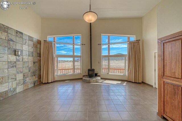 750 Roundup Rd, Westcliffe, CO 81252 - interior space with a wood stove, light tile patterned floors, and a healthy amount of sunlight