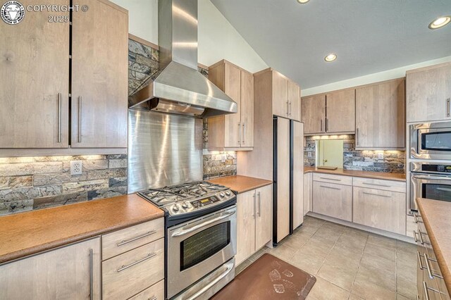 750 Roundup Rd, Westcliffe, CO 81252 - kitchen featuring tasteful backsplash, recessed lighting, light tile patterned floors, extractor fan, and stainless steel appliances