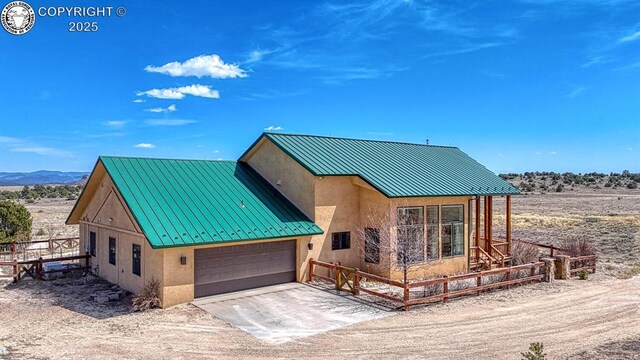 750 Roundup Rd, Westcliffe, CO 81252 - chalet / cabin featuring a garage, metal roof, a standing seam roof, and stucco siding