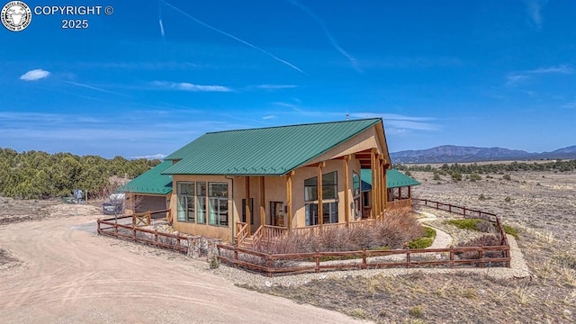 750 Roundup Rd, Westcliffe, CO 81252 - back of house featuring a mountain view, metal roof, driveway, and fence