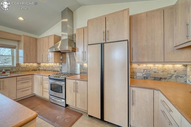 750 Roundup Rd, Westcliffe, CO 81252 - kitchen with light brown cabinets, stainless steel range with gas stovetop, wall chimney exhaust hood, and paneled built in refrigerator