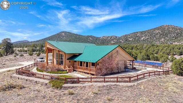 750 Roundup Rd, Westcliffe, CO 81252 - rear view of property featuring a mountain view, fence, and metal roof