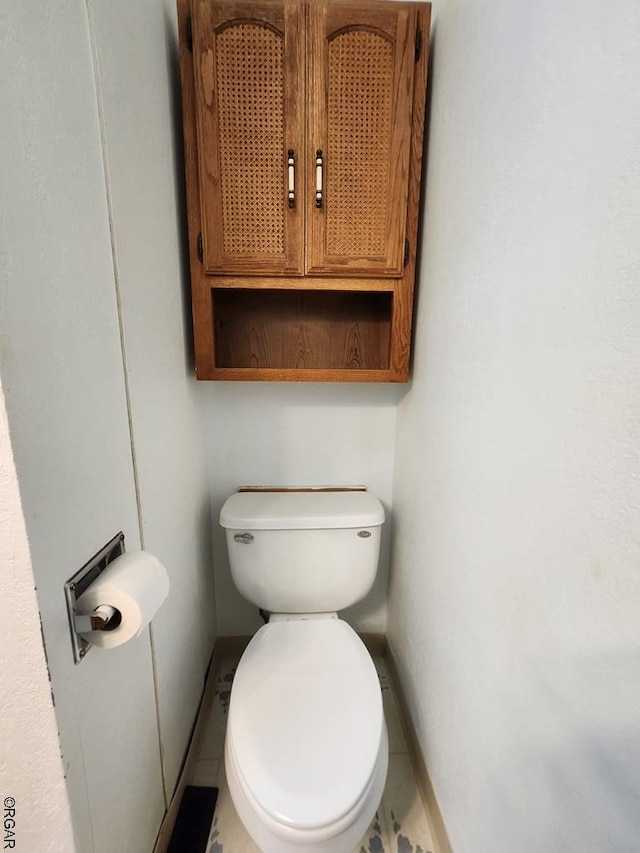 bathroom featuring tile patterned floors and toilet