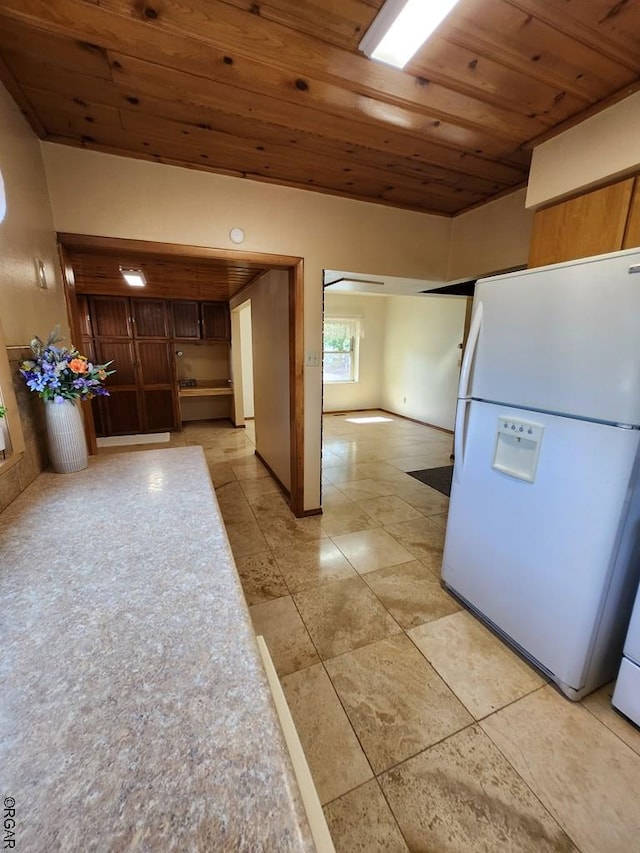 kitchen featuring white fridge and wooden ceiling