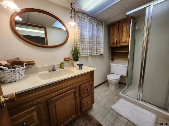 bathroom featuring vanity, a paneled ceiling, an enclosed shower, and toilet