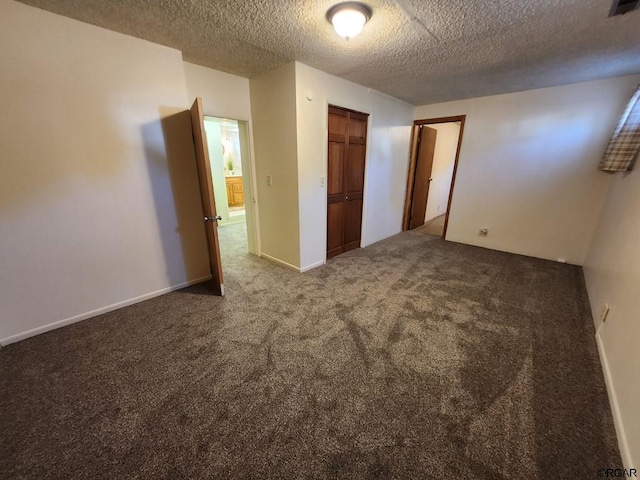 unfurnished bedroom featuring a closet, a textured ceiling, and carpet flooring