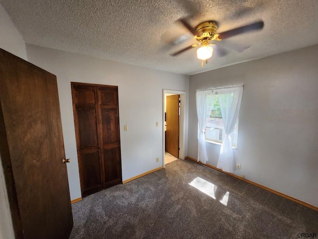 unfurnished bedroom featuring a textured ceiling, carpet floors, and ceiling fan