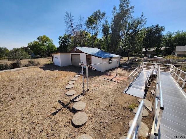 view of yard with a garage and an outdoor structure