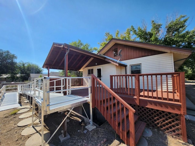 back of house featuring a wooden deck