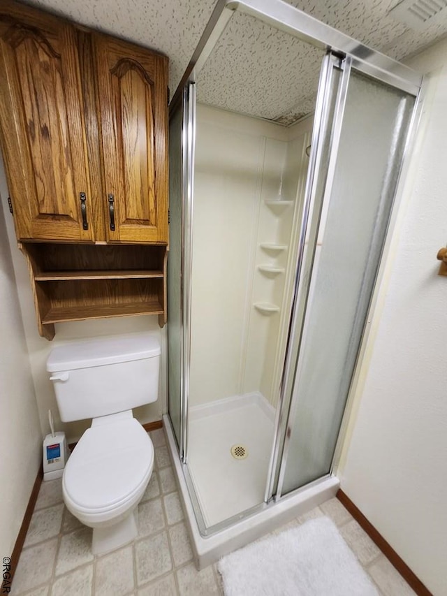 bathroom with walk in shower and toilet