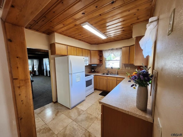 kitchen with sink, backsplash, light carpet, wooden ceiling, and white appliances