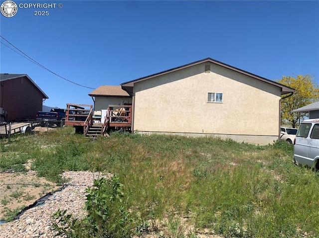 206 Arrowhead Dr, Florence, CO 81226 - view of side of home featuring a deck and stucco siding