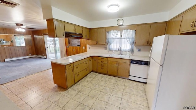 kitchen with sink, wooden walls, kitchen peninsula, white appliances, and a baseboard heating unit