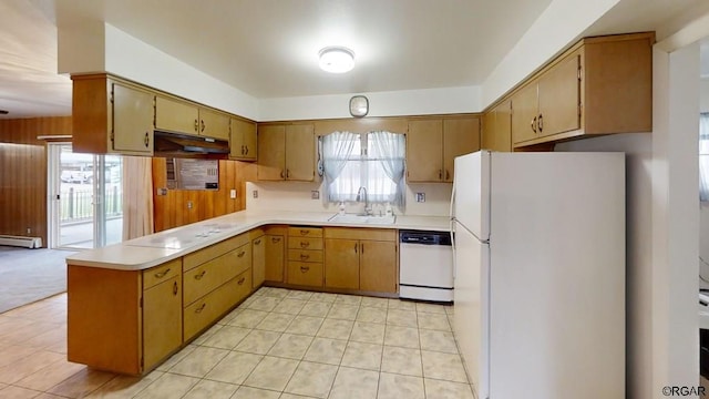 kitchen featuring sink, wood walls, kitchen peninsula, white appliances, and a baseboard heating unit