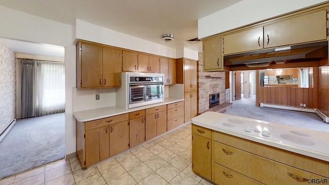 kitchen featuring a baseboard heating unit, light colored carpet, and oven