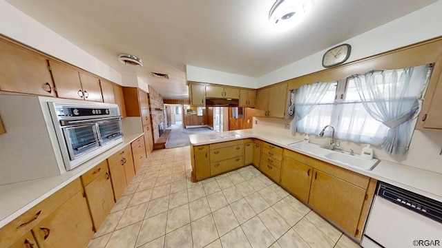 kitchen featuring sink, white appliances, and kitchen peninsula