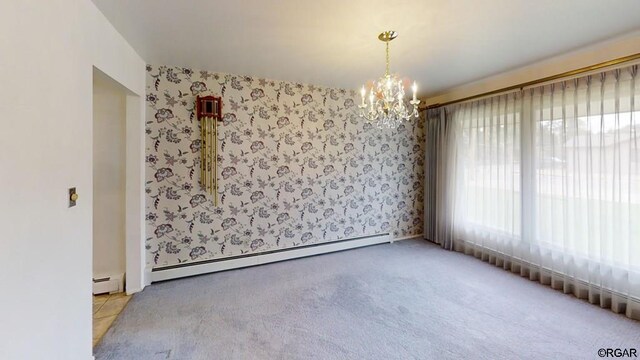 spare room featuring an inviting chandelier, light carpet, and baseboard heating