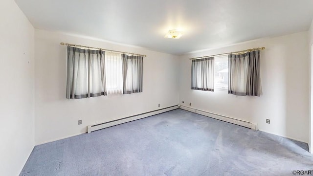 unfurnished room with carpet floors and a baseboard heating unit