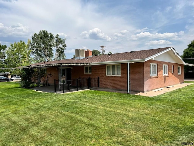 back of property featuring a patio, central air condition unit, and a lawn