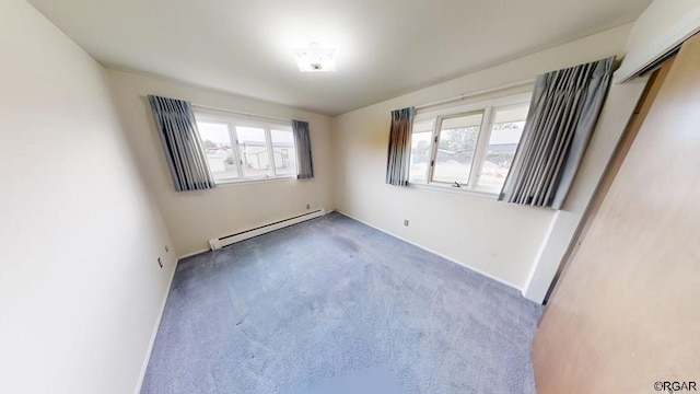 empty room featuring a baseboard heating unit and carpet