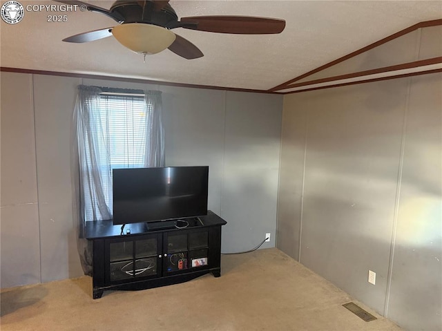 carpeted living room featuring vaulted ceiling and ceiling fan