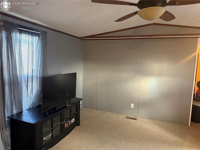 carpeted living room with crown molding, ceiling fan, and vaulted ceiling