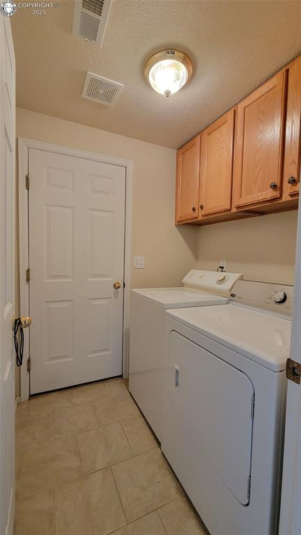 1002 Cedarcrest Dr, Pueblo, CO 81005 - washroom featuring cabinet space, independent washer and dryer, and light tile patterned flooring