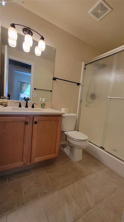 1002 Cedarcrest Dr, Pueblo, CO 81005 - full bath with vanity, a shower stall, and tile patterned flooring