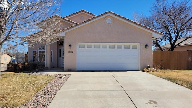 1002 Cedarcrest Dr, Pueblo, CO 81005 - view of front of property with stucco siding, an attached garage, concrete driveway, and a tile roof