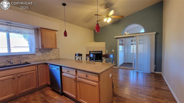1002 Cedarcrest Dr, Pueblo, CO 81005 - kitchen featuring stainless steel dishwasher, a peninsula, a tile fireplace, dark wood finished floors, and vaulted ceiling