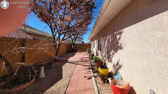 1002 Cedarcrest Dr, Pueblo, CO 81005 - view of home's exterior featuring stucco siding, a fenced backyard, and a patio