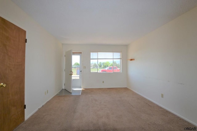 unfurnished room with light colored carpet