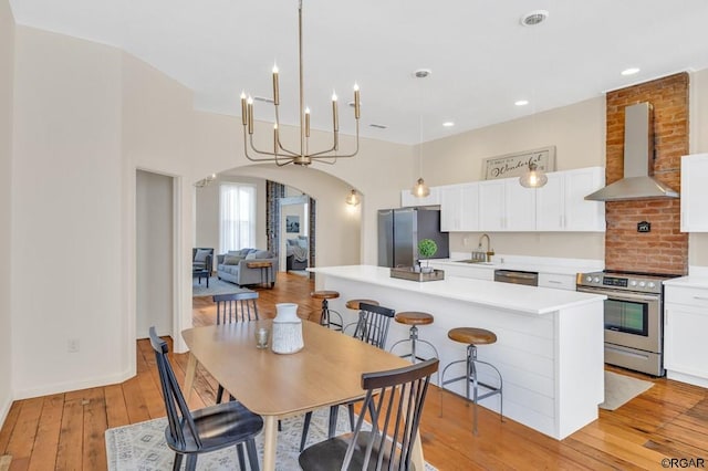 dining area with sink and light hardwood / wood-style flooring