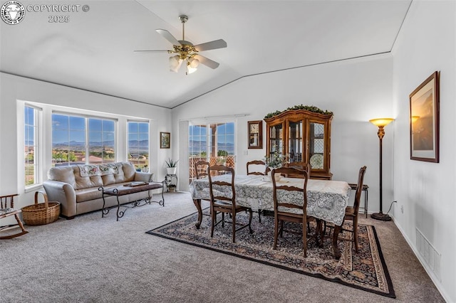 carpeted dining room featuring visible vents, plenty of natural light, ceiling fan, and vaulted ceiling