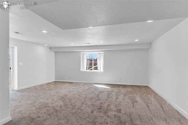 empty room featuring recessed lighting, baseboards, and carpet floors