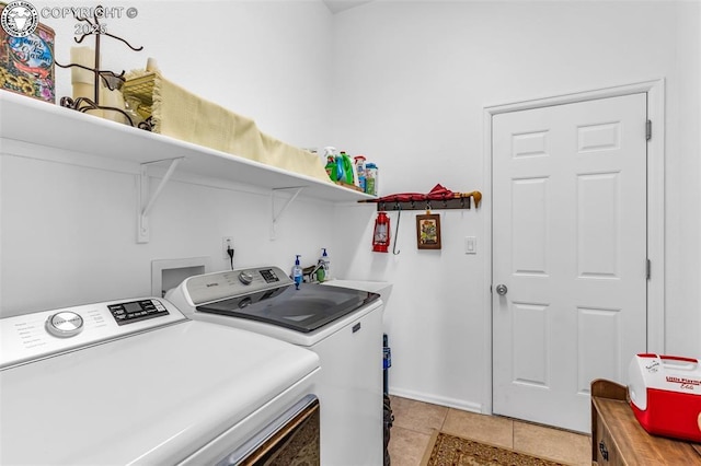 laundry room with light tile patterned floors, separate washer and dryer, laundry area, and a sink