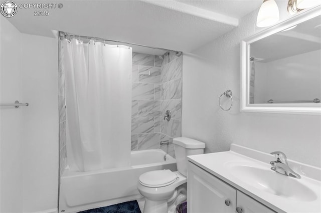 full bath featuring toilet, a textured ceiling, shower / bath combo with shower curtain, and vanity