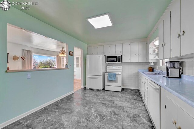 1815 N 10th St, Canon City, CO 81212 - kitchen featuring baseboards, white appliances, white cabinetry, light countertops, and open shelves