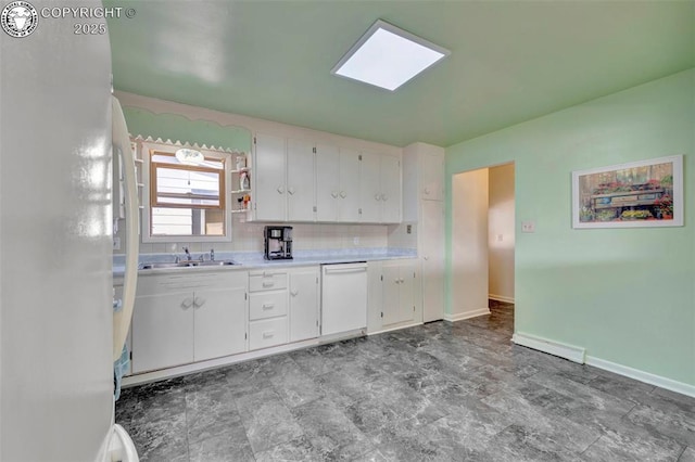 1815 N 10th St, Canon City, CO 81212 - kitchen with a sink, light countertops, white appliances, white cabinetry, and backsplash