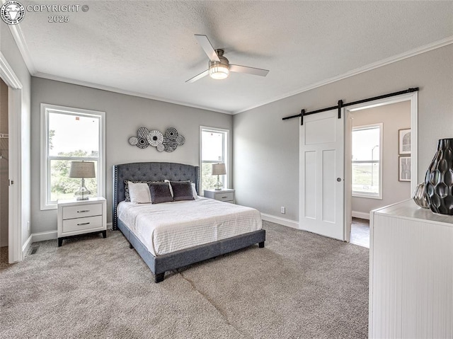 bedroom with crown molding, ceiling fan, multiple windows, light carpet, and a barn door