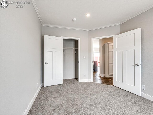 unfurnished bedroom featuring ornamental molding, a closet, and carpet