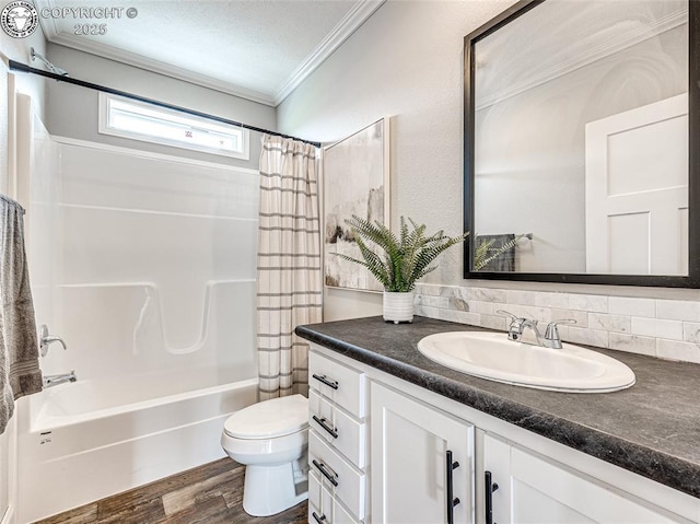 full bathroom featuring toilet, wood-type flooring, ornamental molding, vanity, and shower / bath combo